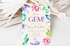 an image of a birthday party card with colorful crystals on the front and bottom, along with palm fronds