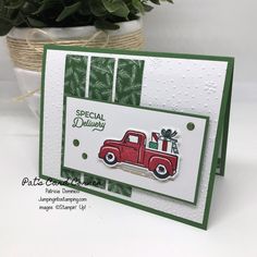 a close up of a card with a truck on it and a potted plant in the background