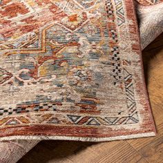 an area rug on the ground with wood flooring and wooden floors in the background