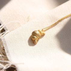 Golden Croissant Necklace, Croissant charm necklace, Stacking French Parisian Twisted Gold dainty necklace This gorgeous croissant - inspired necklace is one piece that will make all of your Parisian dreams come true! Handsculpted, designed, cast and finished in our sunny studio so as to get the best quality and uniqueness for you! There are, also, the slim croissant ring, the chunky one and some other dainty versions that you can stack them up with your new necklace. A sweet addition to your de Croissant Jewelry, Croissant Necklace, Gold Dainty Necklace, Necklace Stacking, Croissant Ring, Wax Carving, Celestial Necklace, Jewellery Inspiration, Inspired Necklace