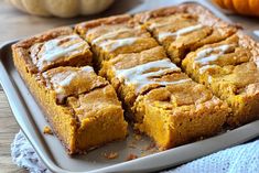 a pan filled with pumpkin bars on top of a wooden table