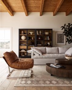 the living room is clean and ready for us to use it's natural wood beams