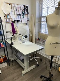 a sewing machine sitting on top of a table next to a dressmaker's mannequin