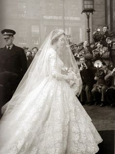 an old black and white photo of a woman in a wedding dress