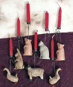 several candles are hanging on the wall with animals