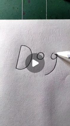 someone is drawing something on paper with scissors