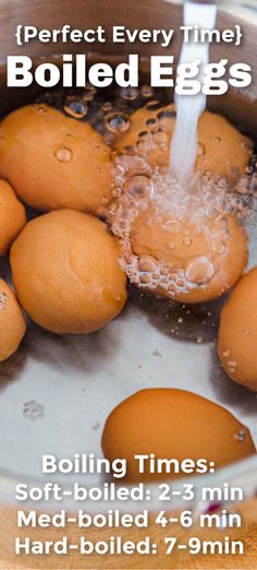 some eggs are boiling in a pot with water coming from the faucet to them