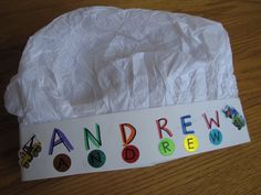 a piece of paper with the word andrew written on it, sitting on top of a wooden table