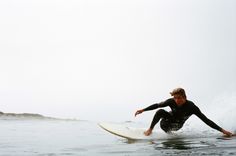 a man riding a wave on top of a surfboard