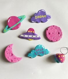 some magnets that are shaped like planets and the words dream written on one of them