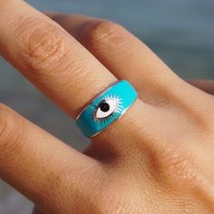 "This Evil Eye Stacking Ring is specifically designed for beautiful women who likes to use stacking rings. The beautiful blue color of this ring will give you the summer vibes, make you feel special and beautiful. Perfect for beach wear. Every Ring comes with a specialized note and jewelry pouch in genuine Somje Gift Box.  It is micron plated in 18K White Gold for a lasting finish and to ensure its hypoallergenic. Dainty rings make the perfect gift! Tarnish Resistant.  A style made for whatever's on your schedule that day. Pair it with your favorite cocktail dress or a casual pair of jeans - either way, this ring is sure to shine. Gift Box & Jewelry Pouch: Your Somje Jewelry will arrive pre-packaged in a genuine branded gift box and jewelry bag. This ring makes a perfect gift for Valentine Blue Sterling Silver Open Midi Rings, Blue Evil Eye Ring, Plating Techniques, Gift Box Jewelry, Dainty Rings, Gift For Valentine, Blue Ring, Evil Eye Ring, Blue Evil Eye