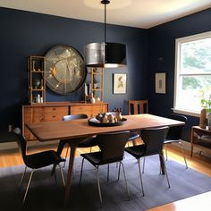 a dining room table with chairs and a clock on the wall