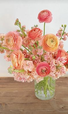 a vase filled with pink and orange flowers