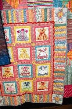 a colorful quilt is hanging on the wall