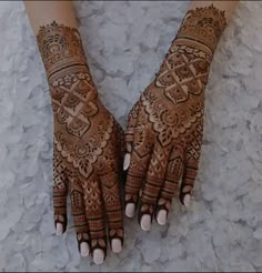 two hands with henna designs on them