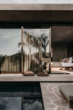 an outdoor living area with sliding glass doors that open up to the pool and outside