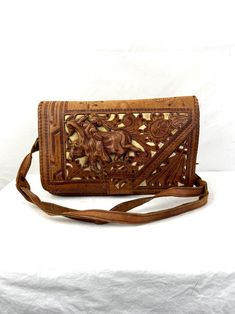 Rare purse! Good overall vintage shape! Amazing bag! Looks to be 50s era. By Davalos - Hecho en Mexico. 3D design Genuine leather. Some wear - see photos.  ~7 1/2" high ~11 1/2" wide 3" deep Vintage Crossbody Clutch For Travel, Vintage Hand-tooled Travel Bag, Vintage Hand Tooled Travel Bag, Vintage Travel Clutch Pouch, Vintage Brown Satchel Clutch, Vintage Everyday Crossbody Clutch, Vintage Leather Crossbody Clutch, Vintage Crossbody Clutch For Daily Use, Vintage Hand-tooled Pouch Bag