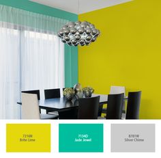 a dining room with green and yellow walls