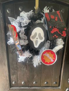 a halloween wreath is hanging on the front door