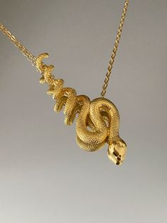 SNAKE NECKLACE This product is brass and gold plated. ♡ The most unique jewelry you can find, perfect gift for you and your loved one. ♡ All of our jewelry is handcrafted with enthusiasm and great care in our workshop. ► HOW TO CARE FOR YOUR JEWELRY * Maintain your jewelry's high shine by avoiding contact with any chemicals such as soap, perfume, lotion, makeup, hair & cleaning products. * Keeping your jewelry in a pouch or a box after using it will prolong the life of your jewelry. * Not recomm Snake-shaped Metal Necklace For Gift, Metal Snake Shape Necklace As Gift, Metal Snake-shaped Necklace For Gift, Snake-shaped Yellow Gold Jewelry For Gifts, Spiritual Gold Snake Chain Necklace, Yellow Gold Snake-shaped Jewelry Gift, Yellow Gold Snake Shaped Jewelry For Gift, Yellow Gold Snake Shaped Jewelry Gift, Unique Personalized Gold Necklaces