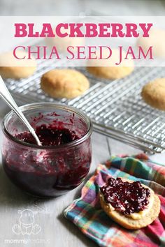 blackberry chia seed jam in a glass jar next to cookies on a cooling rack