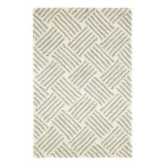 a white and green rug with an abstract pattern