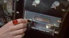 a person is pressing buttons on an old fashioned radio