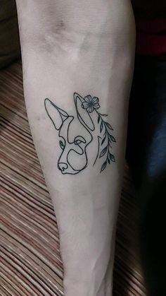 a woman's foot with a tattoo design on the bottom part of her leg