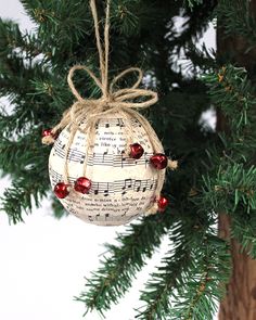 an ornament hanging from a tree with music notes and bells attached to it