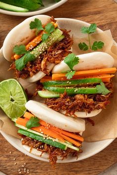 some food is on a white plate with green garnish and carrots next to it