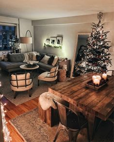 a living room filled with furniture and a christmas tree