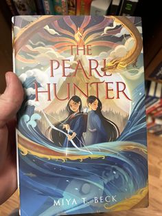 the pearl hunter book cover with two girls holding swords in front of an ocean wave