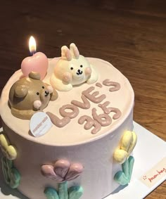 a birthday cake decorated with teddy bears and candles