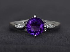 Welcome to my shop, you can find many beautiful gemstone jewelry here, and you also can ask for customized service. Main Stone: natural amethyst, round cut 7X7mm, weighs about 1.24 caratsAccent Stones: czMetal: 925 sterling silver plated with rhodium. I also can provide metal options such as 14k solid yellow/white/rose goldSetting: prong settingmore rings: https://www.etsy.com/shop/XCjewelryStudio?ref=hdr_shop_menuIt's quite comfortable for wearing and suitable for all occasions (wedding, annive Elegant Purple Birthstone Ring With Round Cut, Elegant Purple Round Cut Birthstone Ring, Classic Round Amethyst Birthstone Ring, Amethyst Birthstone Ring With Round Cut, Elegant Round Amethyst Birthstone Ring, Elegant Amethyst Birthstone Ring, Fine Jewelry Amethyst Birthstone Ring, Round Cut, Fine Jewelry Amethyst Birthstone Ring Round Cut, Amethyst Birthstone Ring With Round Stone