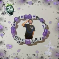 a purple beaded bracelet with an image of a man in the middle and hearts around it