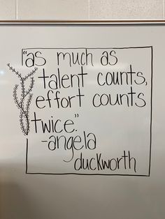 a white board with writing on it in front of a wall mounted sign that reads, as much as talent counts effort counts twice angelia duckworth