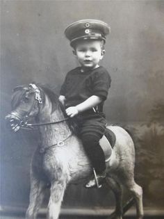 an old photo of a young boy on a horse