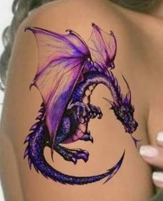 a dragon tattoo on the back of a woman's shoulder and leg, with purple ink