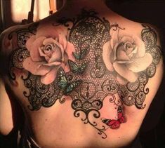 the back of a woman's shoulder with lace and roses tattoo design on it