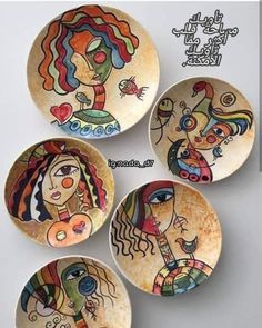 four plates with different designs on them sitting next to each other in the shape of a woman's head