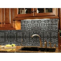 a kitchen with wooden cabinets and granite counter tops, along with an ornate tile backsplash