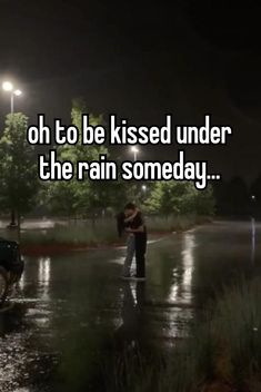 a man and woman kissing in the rain at night with text that reads oh to be kissed under the rain somebody