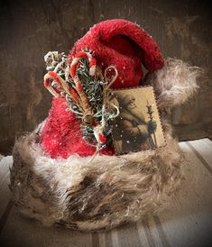 a red santa hat with candy canes and a card on it's side