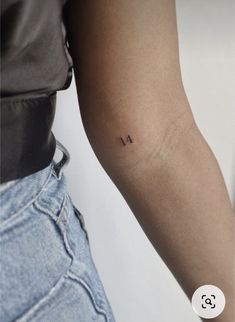 a person with a small tattoo on their arm