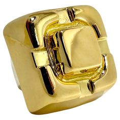 This vintage David Webb treasure is truly monumental in size and scale. The visceral impact that it makes is undeniable. Crafted as one solid piece of highly dimensional 18k yellow gold, it is very simple and at the same time it makes a strong statement. The design area measures a full 1 inch in diameter and rises 5/8 inches above the finger. Inside the ring is a white gold sizing spring stamped with WEBB, copyright, registration marks, and 18k. Ring is size 4 3/4. Gross weight 29.50 grams. Registration Marks, Spring Stamps, David Webb, Gold Cocktail Ring, Gold Cocktail, Madison Avenue, Cocktail Ring, Cocktail Rings, Vintage Stil