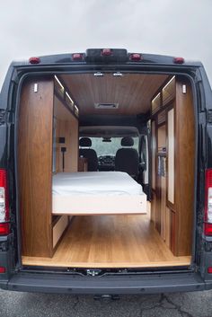 an image of the back of a van with its bed pulled up to it's side