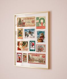 a framed christmas postcard is hanging on the wall next to a shelf filled with stamps