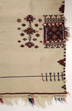 an old rug with fringes and designs on it