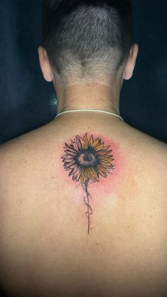 a man with a sunflower tattoo on his back