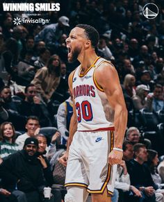 a basketball player with his mouth open in front of an audience